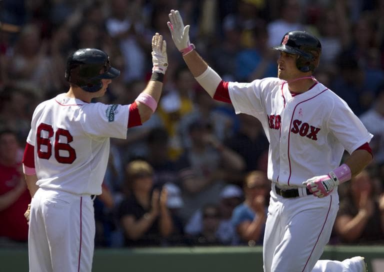 Boston Red Sox's Will Middlebrooks, right, is welcomed to home plate by teammate Daniel Nava after hitting a home run against Cleveland on Sunday. (AP)