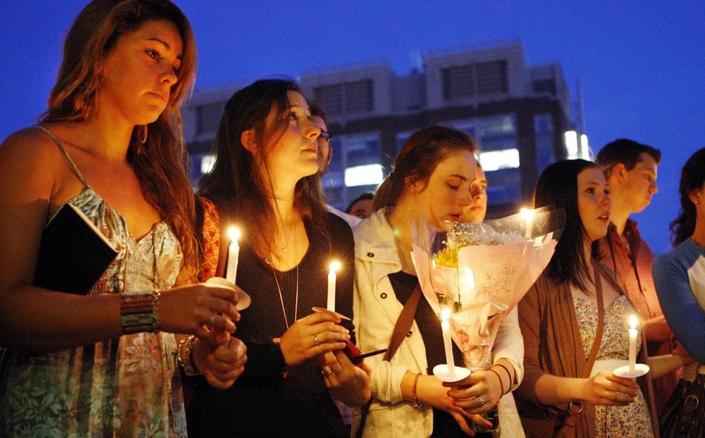 Students including Tori Pinheiro, left, victim Austin Brashears' girlfriend, hold a candlelight vigil on Marsh Plaza at Boston University Saturday night. (AP)