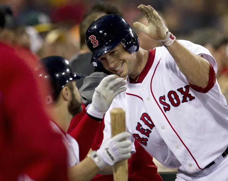 Daniel Nava is welcomed into the dugout after hitting a two-run home run off Seattle Mariners' Jason Vargas on Monday. (AP)