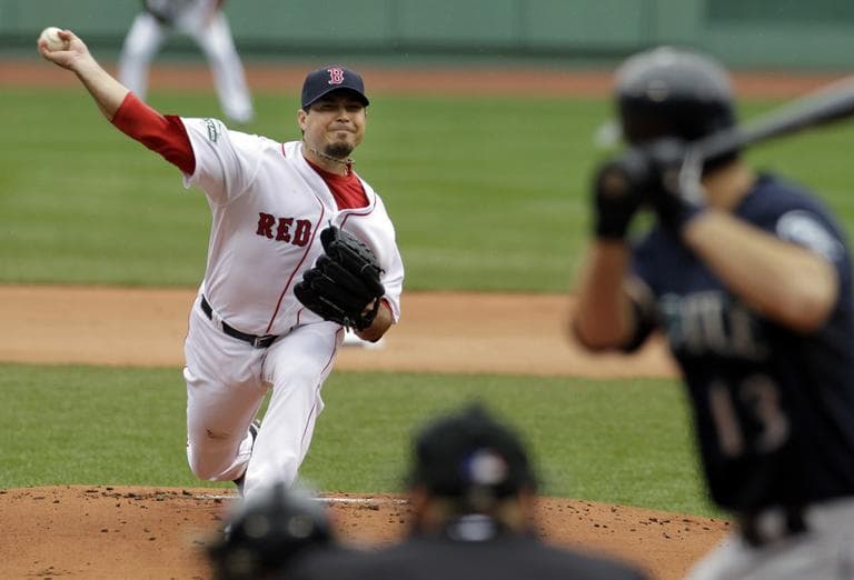 Josh Beckett delivers to Seattle Mariners' Dustin Ackley in the first inning at Fenway Park. Beckett pitched 7 shutout innings, earning the win. (AP)
