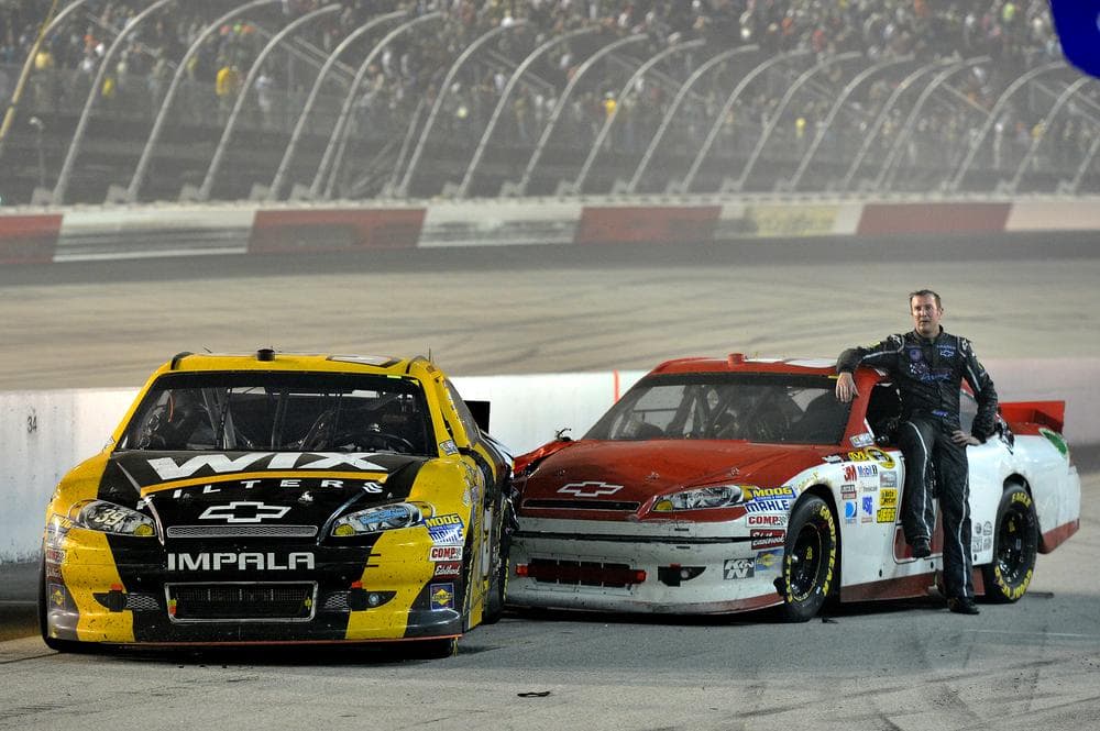 Kurt Busch (51) sits on his damaged car after hitting Ryan Newman's car on pit road after Saturday's race at Darlington. (AP Photo/Autostock, Brian Czobat)