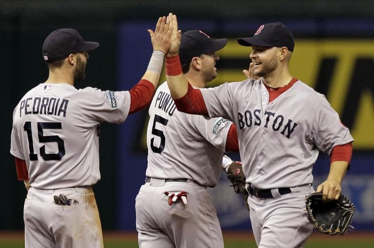 Red Sox's Cody Ross, right, high-fives teammates Dustin Pedroia, left, and Nick Punto after they defeated the Tampa Bay Rays 5-3 during a baseball game on May 17 in St. Petersburg, Fla. (AP Photo/Chris O'Meara)