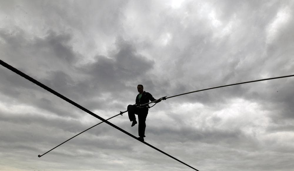 Nik Wallenda performs a walk on a tightrope in the rain during training for his walk over Niagara Falls in Niagara Falls, N.Y. (AP)