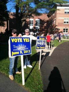 Supporters of the Taunton casino proposal hold signs outside the city council meeting, Thursday, May 24. (Monica Brady-Myerov/WBUR)