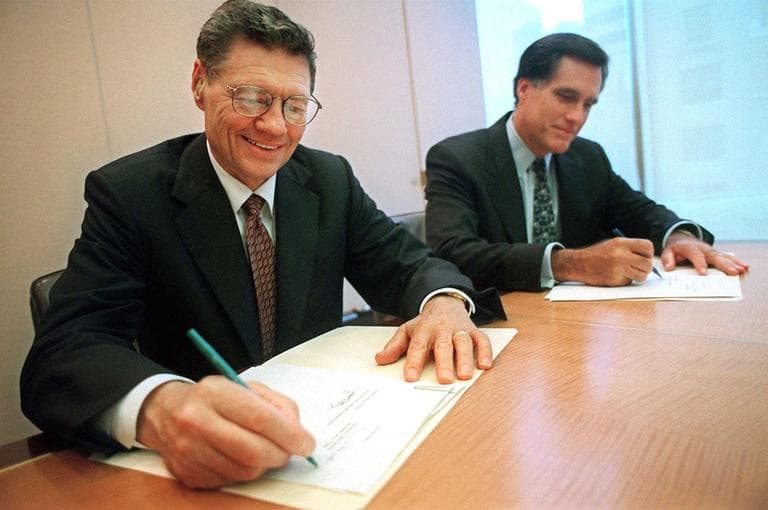 Thomas S. Monaghan, founder and chairman of Domino's Pizza, Inc., left, and Mitt Romney, managing director of Bain Capital, Inc., sign an agreement for Monaghan to sell a "significant portion" of his stake in the company to Bain Capital Sept. 25, 1998, in New York. (AP)