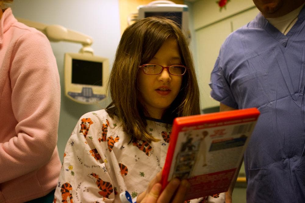 Riley chooses a movie to watch for her 2 1/2 hours MRI scan at Children's Hospital Waltham, MA. (Jesse Costa/WBUR)