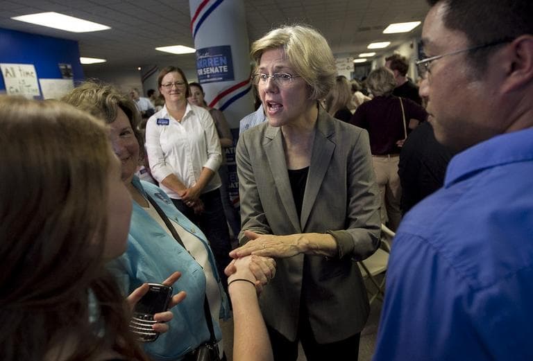 Democratic U.S. Senate candidate Elizabeth Warren, center, greets people during an event at Warren's campaigns headquarters, in Somerville on Wednesday. (AP Photo/Steven Senne)