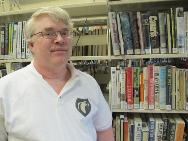 War historian John Gawne, author of book on the Ghost Army, wearing the Ghost Army's unofficial insignia. (Andrea Shea/WBUR)