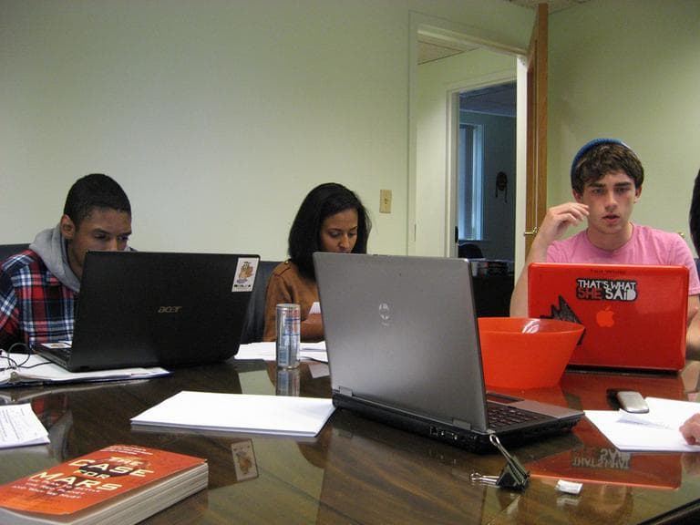 Ted White, far right, prepares the arguments he will make at the National Forensics League national competition. Heaven Reda, center, and James MacGlashing of Urban Science Academy also qualified for the national competition (Beenish Ahmed for WBUR)