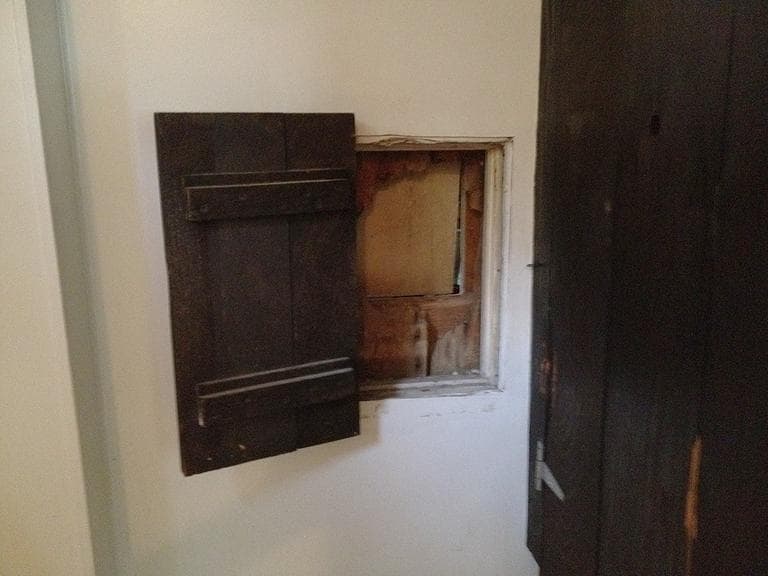 The Nimrod restaurant in Falmouth has preserved the cannon ball hole in the men's room wall behind a small wooden door, from when it was struck in 1814 (Courtesy)