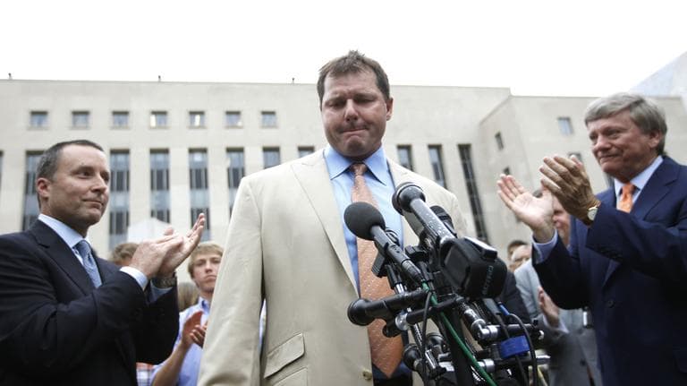 Former Major League Baseball pitcher Roger Clemens, center, is applauded by his attorney's, Rusty Hardin, right, and Michael Attanasio, left, outside federal court in Washington, Monday. (AP)