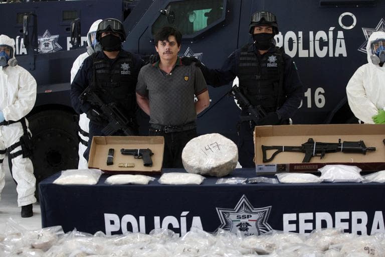 Federal police agents present Jaime Herrera, alias "El Viejito," alleged member of the Pacific drug cartel, to the press in Mexico City, Tuesday Feb. 14, 2012. (AP)