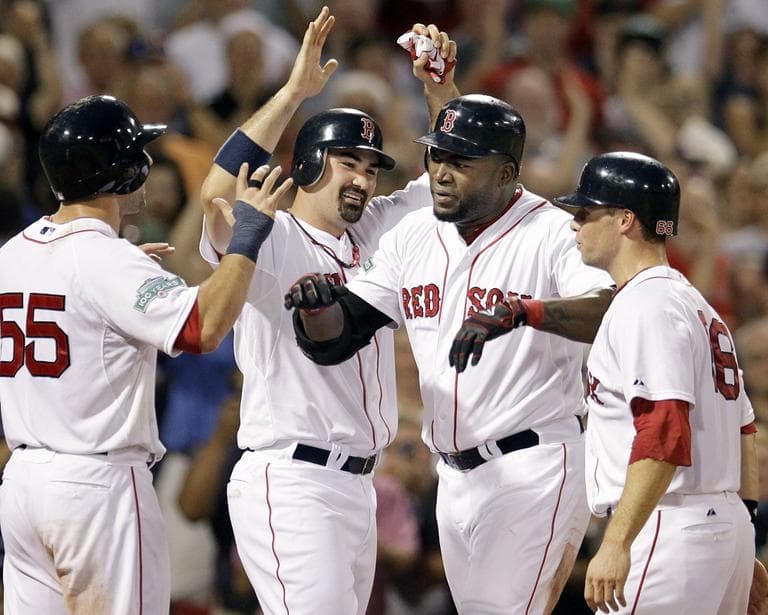 David Ortiz celebrates his grand slam with his teammates at Fenway Park on Wednesday. (AP)