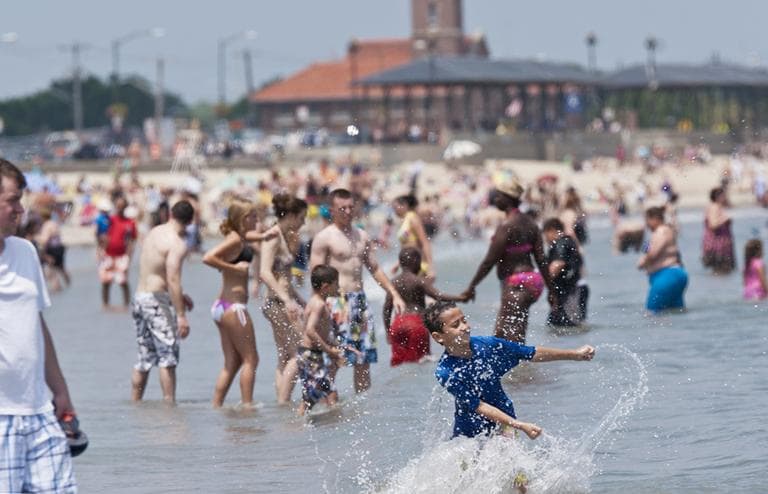 Children play in the water at Revere Beach, Thursday (Josh Berlinger for WBUR)
