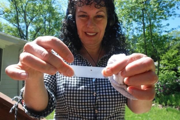 Carey Goldberg and the tick she encountered while reporting this story. (George Hicks/WBUR)