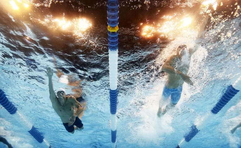 Michael Phelps, left, and Conor Dwyer swim in the men's 200-meter freestyle preliminaries at the U.S. Olympic swimming trials, Tuesday, June 26, 2012, in Omaha, Neb. (AP)