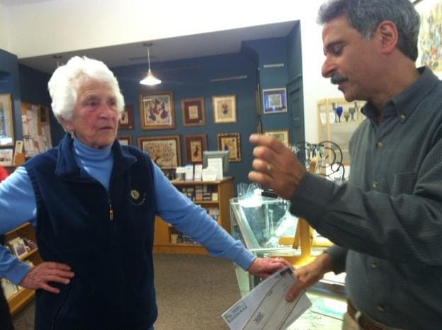 Nancy Schon, left, seen here with Larry Hardoon, owner of a 34-year-old gallery containing much of Schon's Judaica. (Andrea Shea/WBUR)
