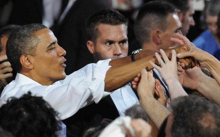 President Barack Obama greets the crowd after a campaign stop at the historic Fire Station No.1, in downtown Roanoke, Virginia, Friday, July 13, 2012. Obama traveled to southwest Virginia to discuss choice in this election between two fundamentally different visions on how to grow the economy, create middle-class jobs and pay down the debt. (Don Petersen/AP)
