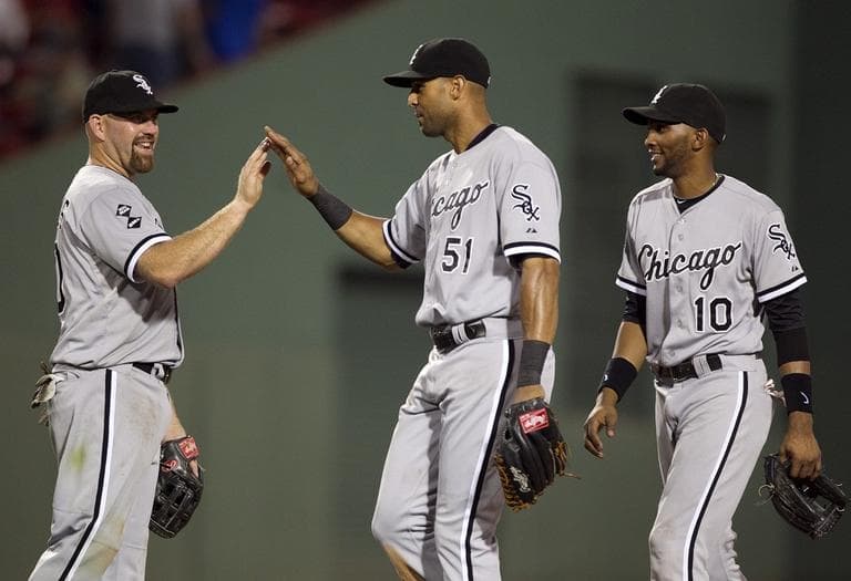 Chicago White Sox's Kevin Youkilis, left, celebrates with teammates Alex Rios, center, and Alexei Ramirez, right, after defeating the Red Sox 7-5 on Tuesday. (AP Photo/Steven Senne)