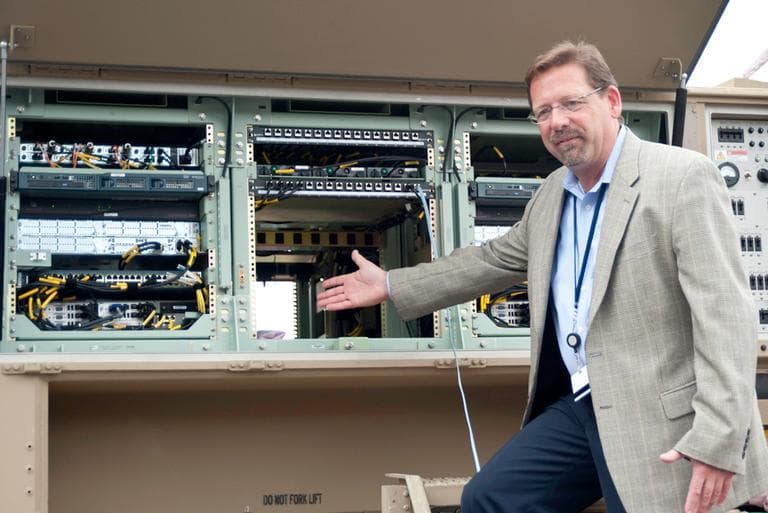 Chris Marzilli, president of General Dynamics C4 Systems, describes the fully equipped military vehicles, laden with General Dynamics communication software. The Taunton-based complex faces federal defense cuts. (Courtesy General Dynamics).