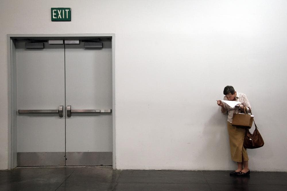 Social critic Charles Derber says we have more people who need or want jobs than our existing economic structure provides. Enter, the surplus American. In this photo, job seeker Tammy Syniec reads the list of employers participating at a job fair expo in Anaheim, Calif., June 13, 2012. (AP Photo)