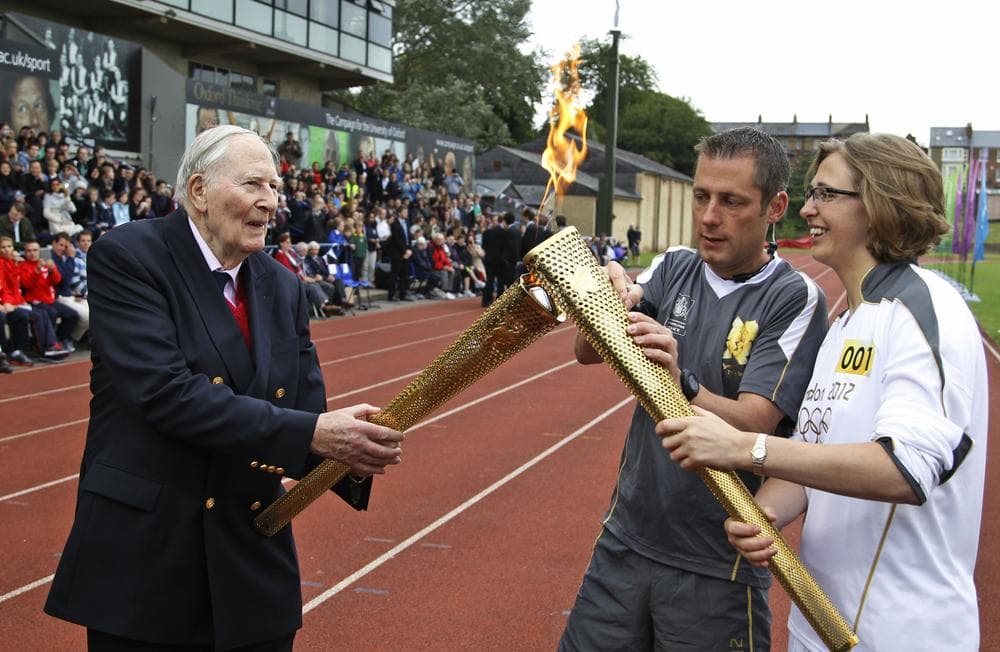 Britain's Sir Roger Bannister, left, broke the four-minute mile barrier in 1954, a feat that has lost some luster in today's track and field. (AP)