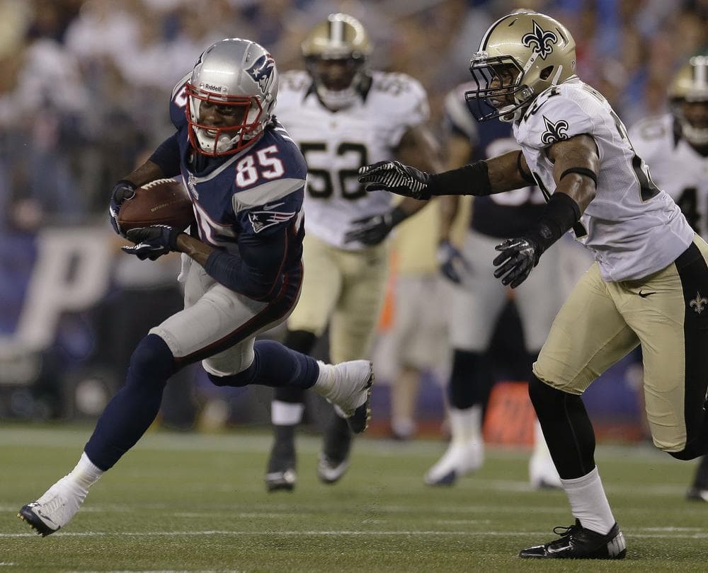 New England Patriots rookie wide receiver Brandon Lloyd pulls away from New Orleans Saints strong safety Corey White after Lloyd caught a Tom Brady pass during their first preseason game last night. (AP Photo)