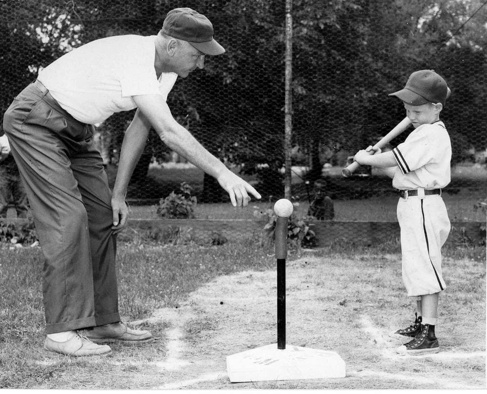 Jerry Sacharski, left, gives instructions to 5-year-old Craig LeClair in 1958. (AP/Frank Passic via Battle Creek Enquirer) 