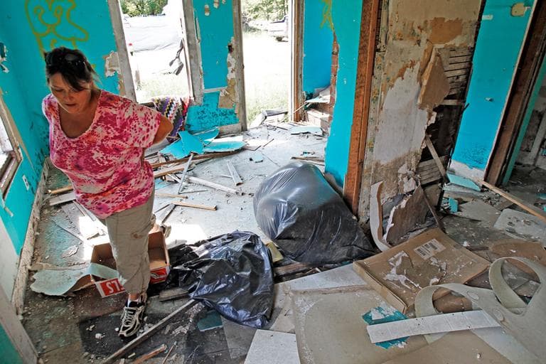 On Aug. 17, 2012, Janet Lumbra looks over the Irene-damaged remains of her home in East Granville, Vt. (AP)