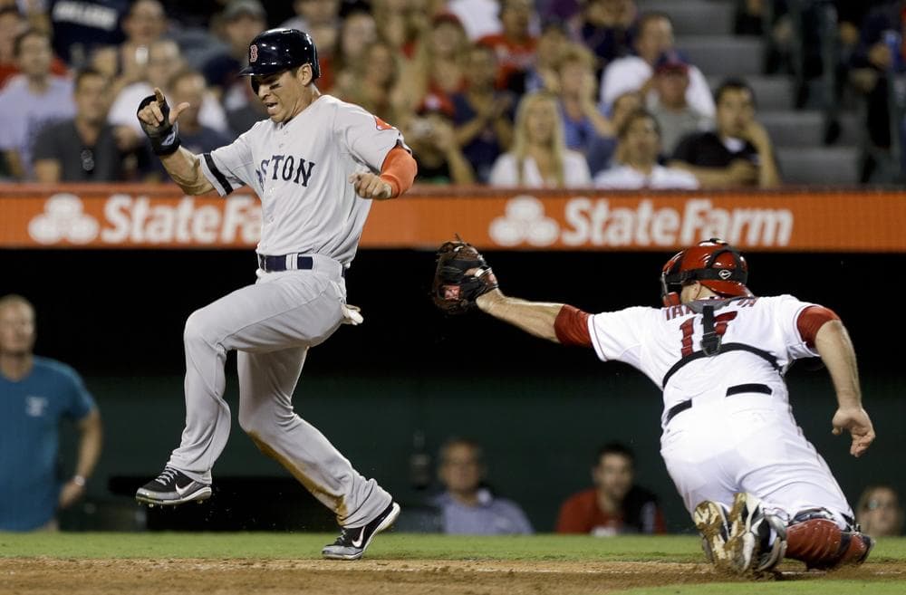 Boston's Jacoby Ellsbury scores past Los Angeles catcher Chris Iannetta on a hit by Dustin Pedroia during the fifth inning of last night's game in Anaheim. (AP Photo)