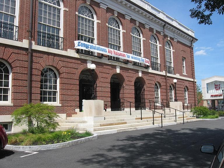 Needham Town Hall with a sign congratulating Raisman (Lynn Jolicoeur for WBUR)