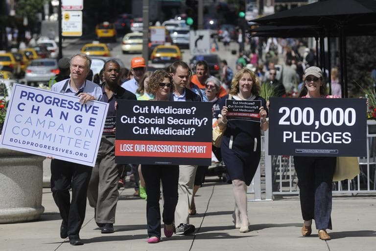 Members of Progressive Change Campaign Committee upset over potential cuts to Medicare, Medicaid and Social Security walks to President Obama's campaign headquarters to deliver 200,000 signatures from people who are refusing to donate or volunteer for his re-election campaign if Obama cuts entitlement programs, Friday, July. 15, 2011 in Chicago. (AP)