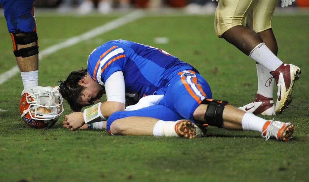 University of Florida quarterback John Brantley crouches on the field after being hit in a game against Florida State. (AP)