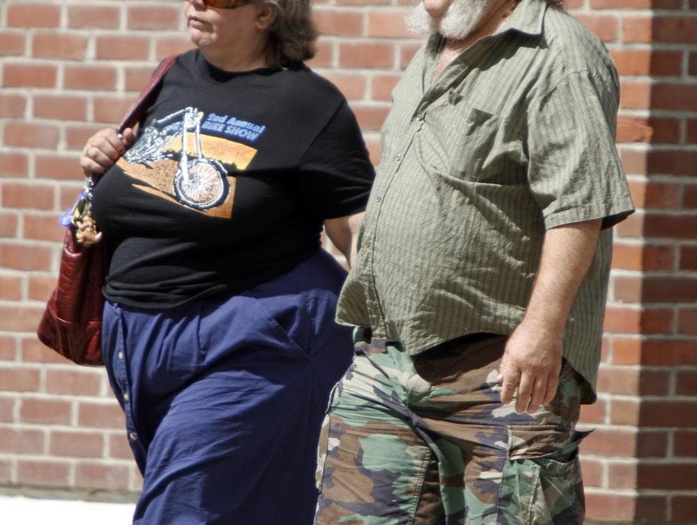 People walk on the street, Thursday, July 7, 2011, in Montpelier, Vt. National statistics show that Vermont is dropping from its perch near the top of national rankings of the least obese states. In 1995, 13.4 percent of Vermonters were considered obese. Now the figure is 23.5. (AP)