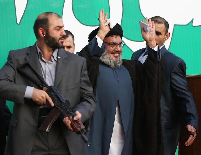 Hezbollah leader Sheik Hassan Nasrallah, center, escorted by his bodyguards, waves to a crowd of tens of thousands of supporters during a rally denouncing an anti-Islam film that has provoked a week of unrest in Muslim countries worldwide, in Beirut, Lebanon on Monday. (AP)