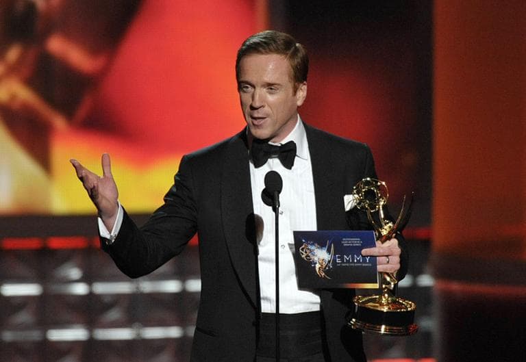Damian Lewis accepts the award for Outstanding Lead Actor In A Drama Series for "Homeland" at the Emmy Awards on Sunday. (AP)