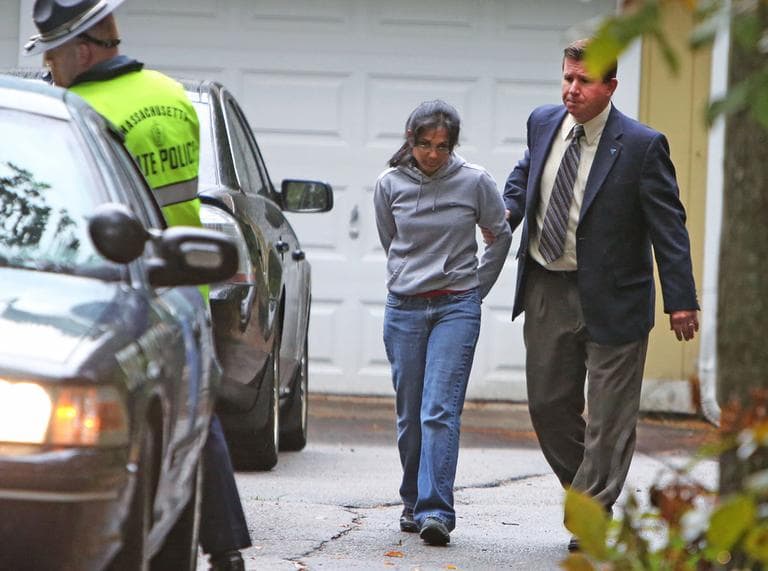 Annie Dookhan, center, is escorted to a police cruiser outside her home in Franklin on Friday. (AP)
