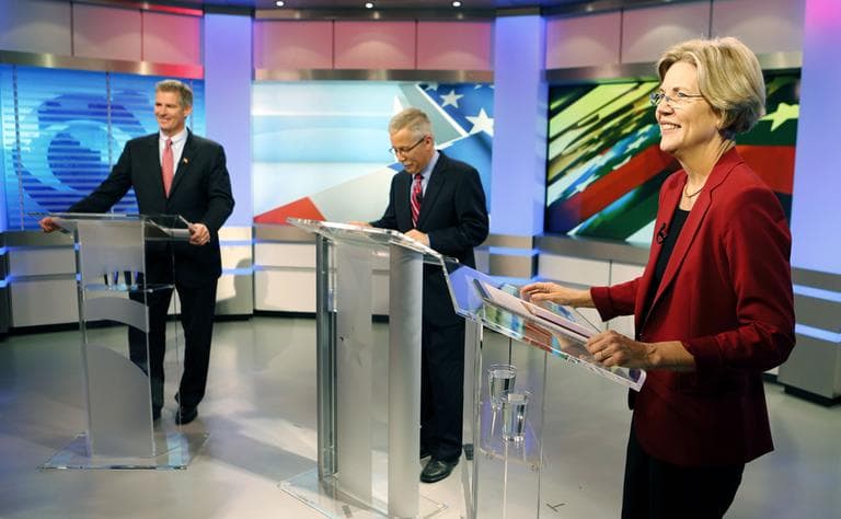 Sen. Scott Brown and his Democratic challenger Elizabeth Warren prepare for their first debate with moderator Jon Keller on Sept. 20 in Boston. (AP)