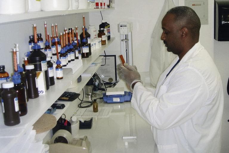 A pharmacist mixes medication at a compounding pharmacy in West Palm Beach, Fla. Thousands of these pharmacies operate nationwide. A compounding pharmacy in Massachusetts has been blamed for a deadly outbreak of fungal hepatitis. (AP/Brian Skoloff)