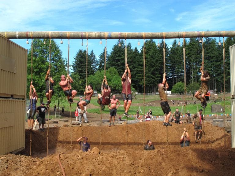 Competitors tackle an obstacle during the Pacific Northwest "Spartan Sprint" in June. Outside magazine reports the Spartan Race series, which attracted nearly half a million participants last year, has contemplated testing for doping violations. (AP/Rachel La Corte)