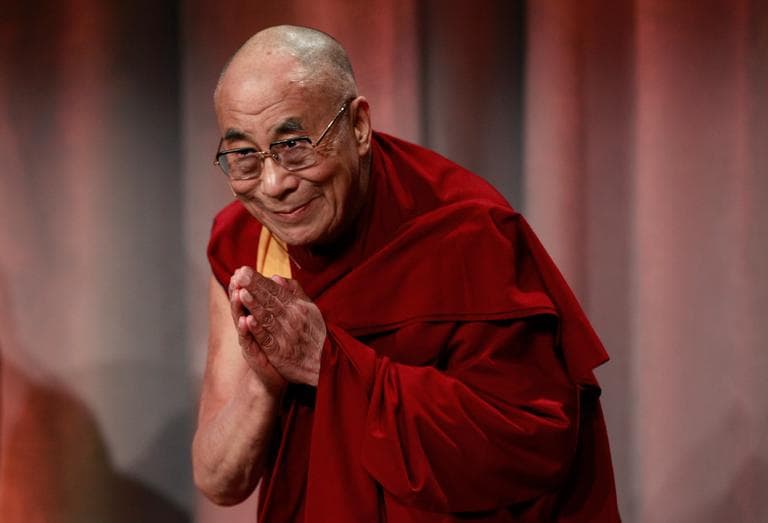 Tibetan exiled spiritual leader the Dalai Lama bows to an audience as he takes the stage at the start of an event called "Beyond Religion: Ethics, Values and Well-Being," at a Boston hotel Sunday. (Steven Senne/AP)