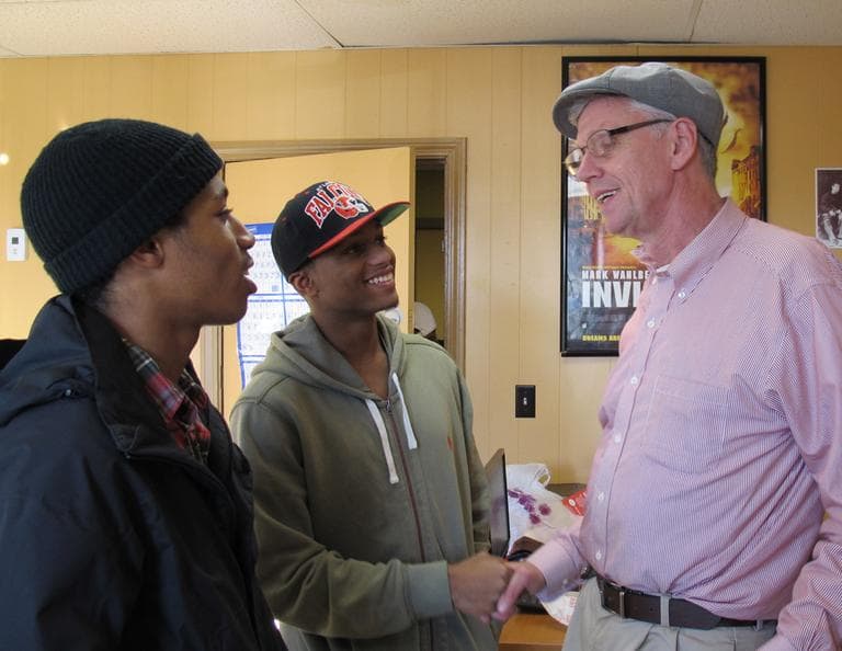 Emmett Folgert, of the Dorchester Youth Collaborative, talks with Stephen Goss and Kurt Driggs. (Monica Brady-Myerov/WBUR)