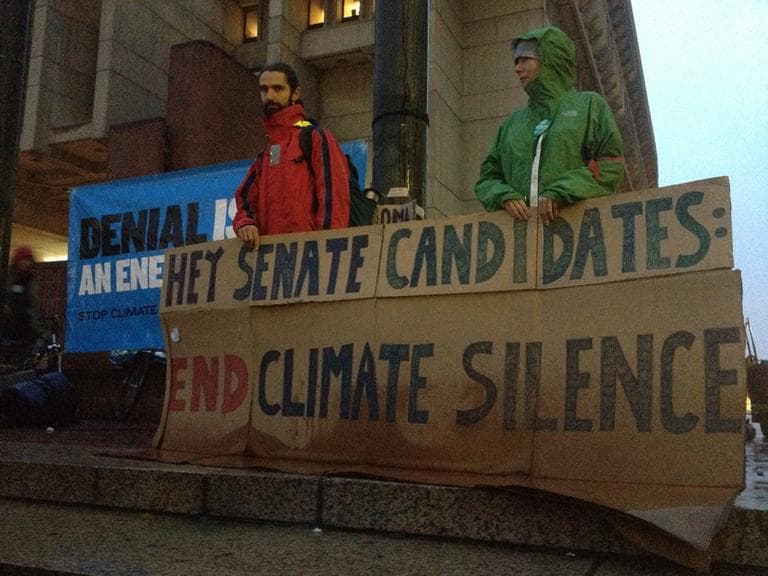 Members of the group "Massachusetts 350" stand vigil in Boston, hoping to increase attention to climate change in the U.S. Senate race. (Martha Bebinger/WBUR)