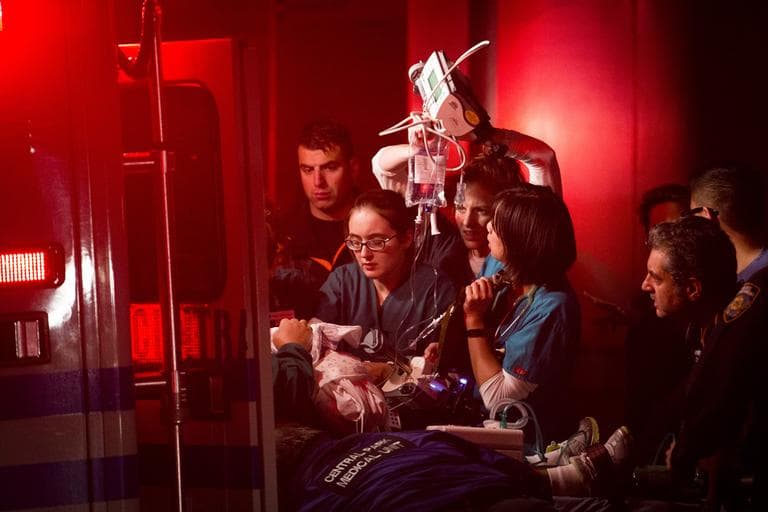 Medical workers assist a patient into an ambulance during an evacuation of New York University's Tisch Hospital on Monday. (John Minchillo/AP)