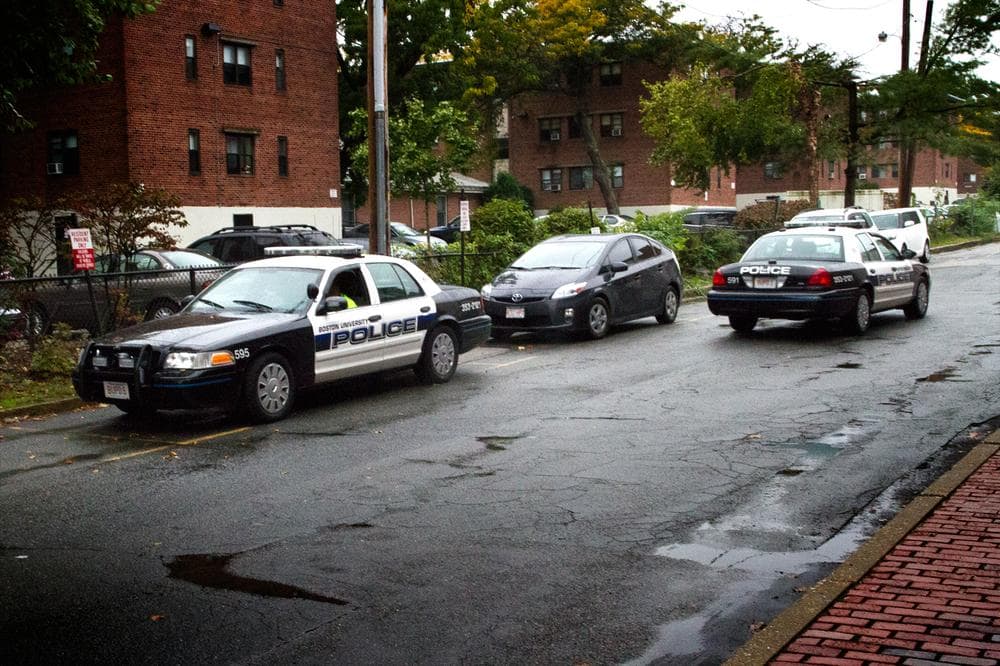 Boston University police cars patrol near the campus' Boston/Brookline border on Wednesday. (Jesse Costa/WBUR)