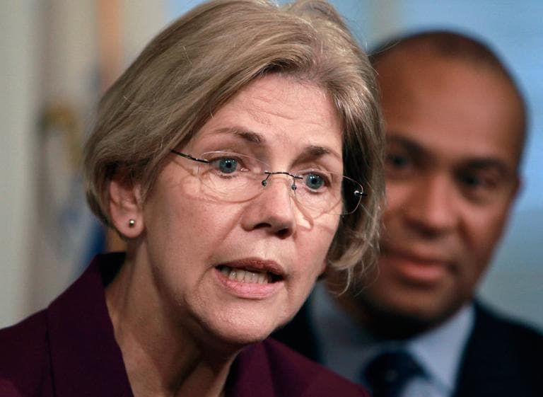 U.S. Sen.-elect Elizabeth Warren, with Gov. Deval Patrick behind her, at a State House news conference Thursday (Steven Senne/AP)