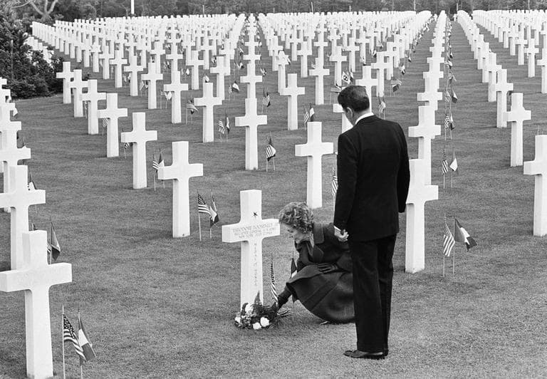 Nancy Reagan puts down a bunch of flowers at the grave of Theodore Roosevelt Jr. at the Normandy American Cemetery at Omaha Beach, France, as the Pres. Ronald Reagan stands behind her. (Bob Daugherty/AP)