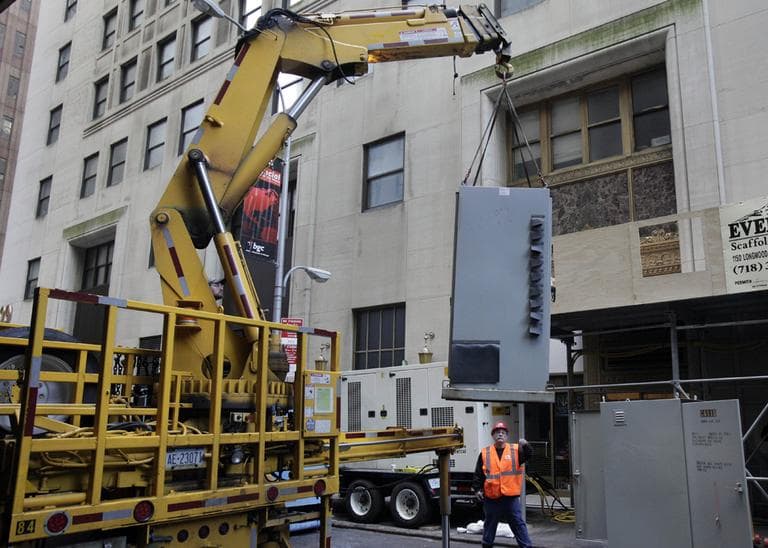 Replacement power switches are off-loaded from a truck in New York's Financial District, Monday, Nov. 12, 2012. (Richard Drew/AP)