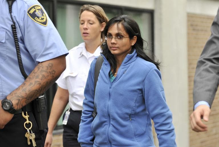 In a Oct. 10, 2012 file photo, Annie Dookhan, leaves a Boston courthouse escorted by court officers and her lawyer. (Josh Reynolds/AP File)