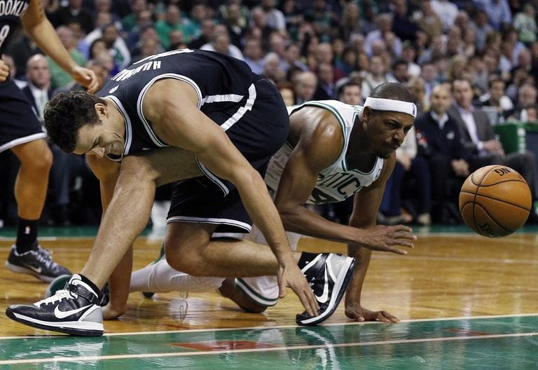 Brooklyn Nets' Kris Humphries, left, and Celtics' Paul Pierce scramble for a loose ball.(AP/Michael Dwyer)